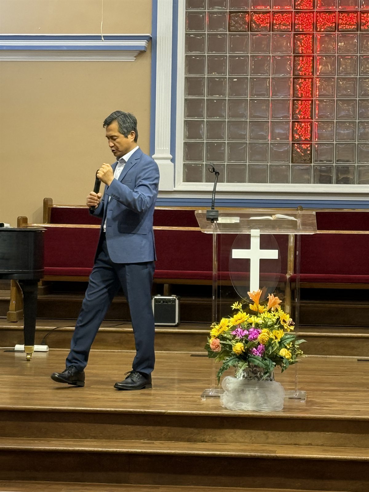 Pastor John teaching during worship