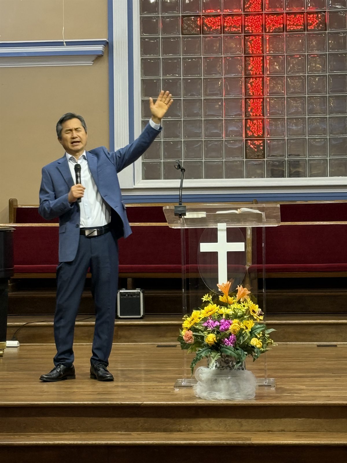 Pastor John leading the church in prayer